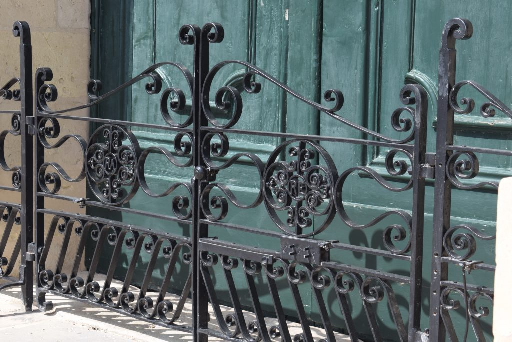 Auberge de Castille. Detail of wrought-iron gate showing initials of Royal Engineers and Royal Artillery.