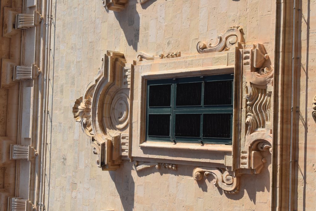 Detail of mouldings around windows on piano nobile. Note the crescent motif over the window.