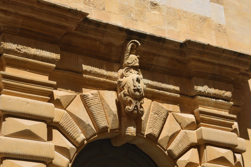 Auberge d'Italie. Detail of symbols over main portal.